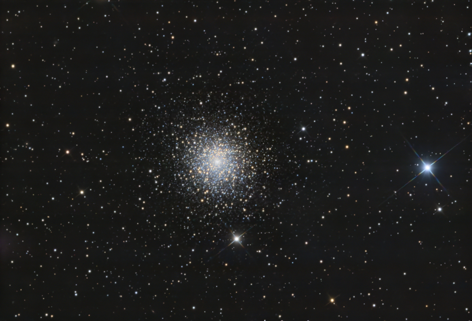 The globular cluster Messier 15 is one of the densest ever discovered, with very hot blue stars and cooler orange stars concentrated toward its bright core. M 15 is located in the constellation Pegasus, 33,600 light-years from Earth.